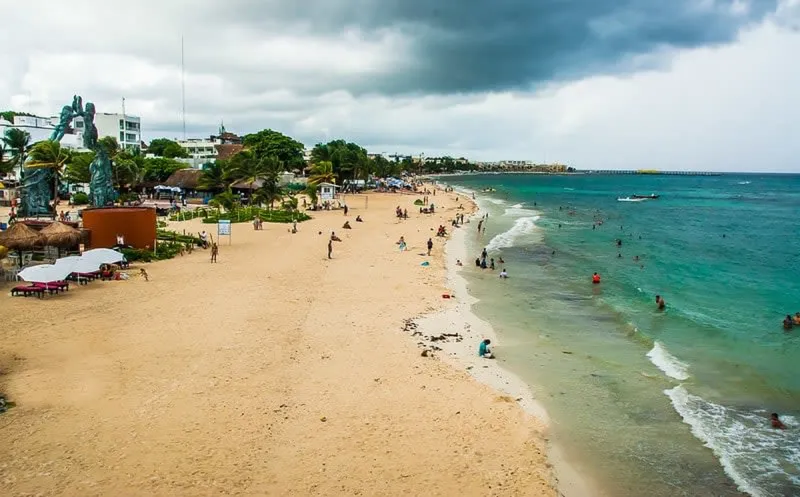 Sunny beach chairs facing the Caribbean water in Playa del Carmen