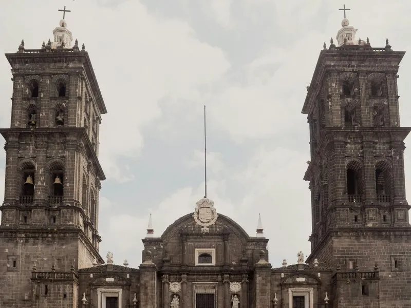 Puebla Cathedral on the main plaza with twin baroque bell towers and colonial buildings surrounding the Zócalo