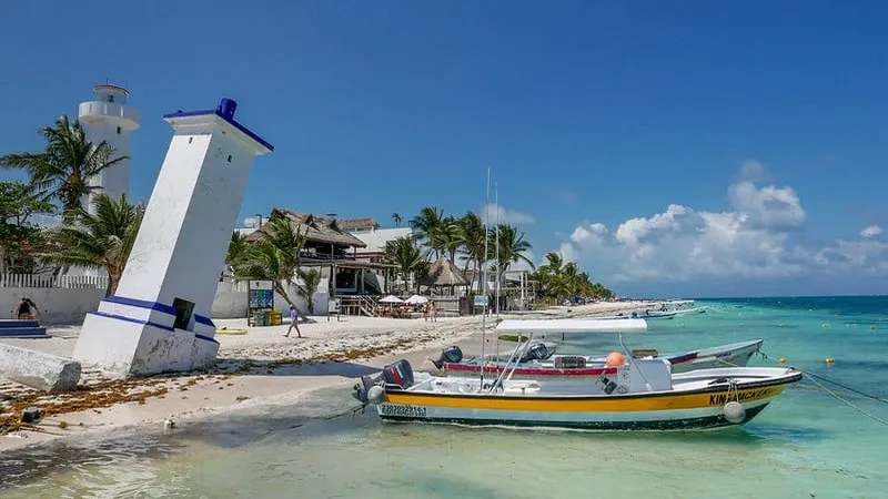 Puerto Morelos beach with shallow Caribbean water and clouds offshore