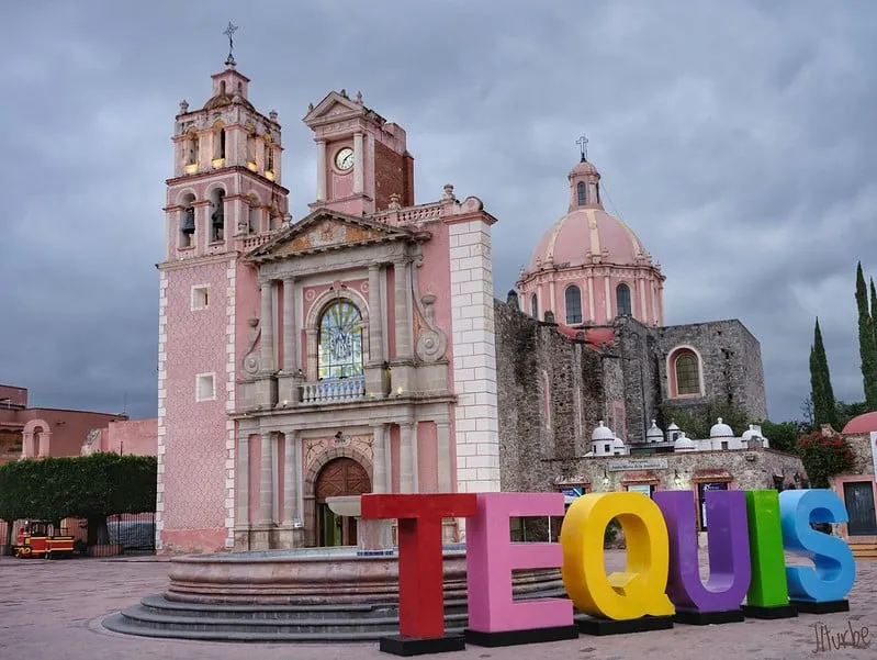 Tequisquiapan main plaza and colonial arcaded buildings in the Querétaro wine and cheese region — a peaceful town square with stone arches and leafy trees
