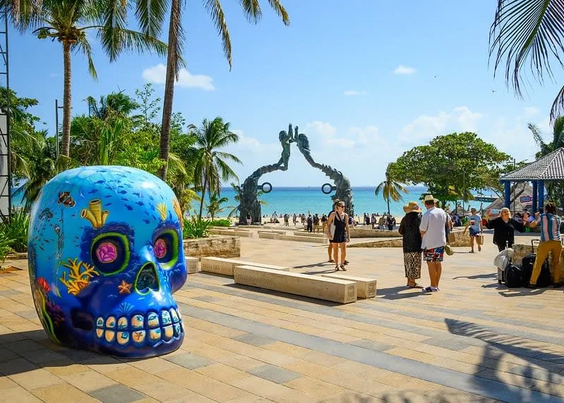 Palm-lined Playa del Carmen beach with turquoise water near the Riviera Maya