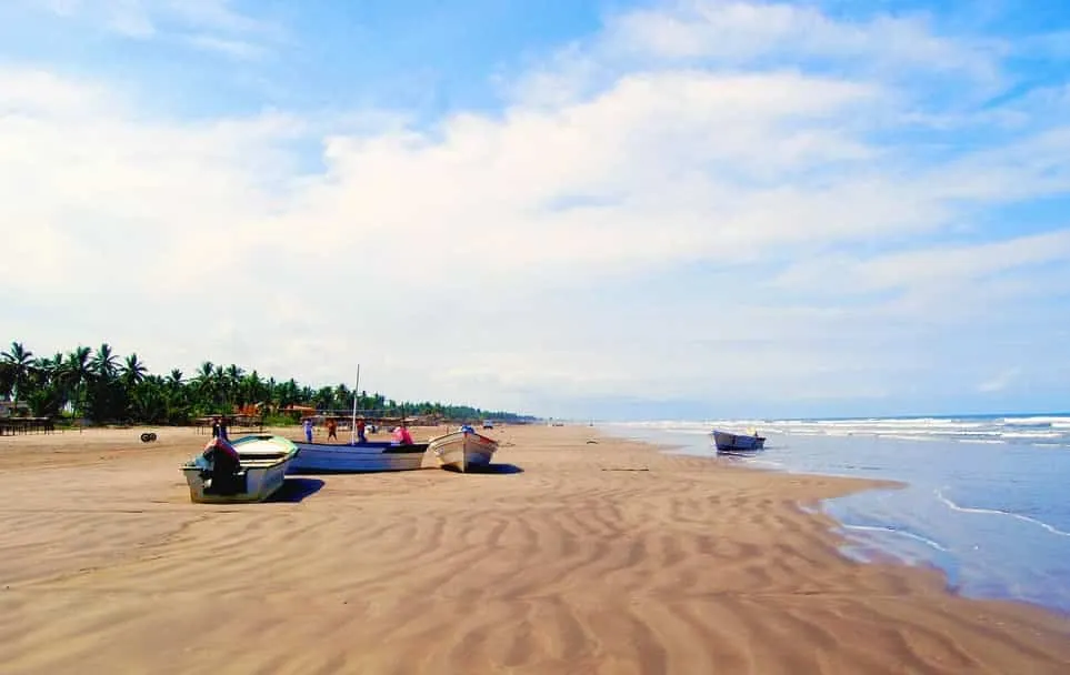 El Novillero beach with shallow waves stretching across a wide sandy shore