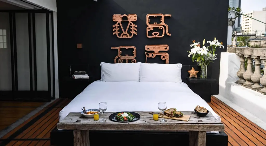 La Valise boutique hotel suite with warm wood and balcony light