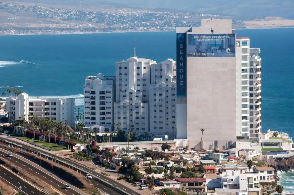 Broad sandy shoreline with hotel towers in the background