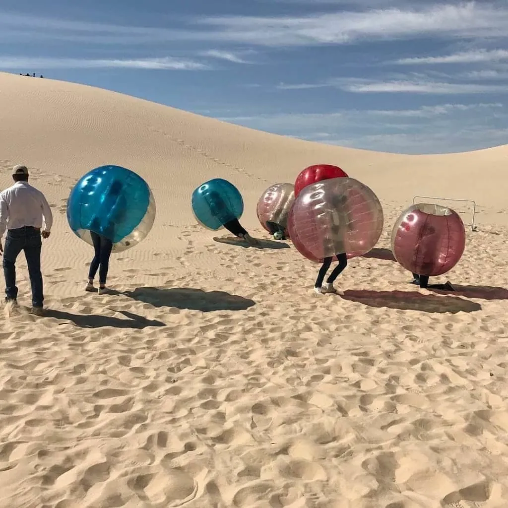 Bubble soccer activity set up on the sand at Samalayuca