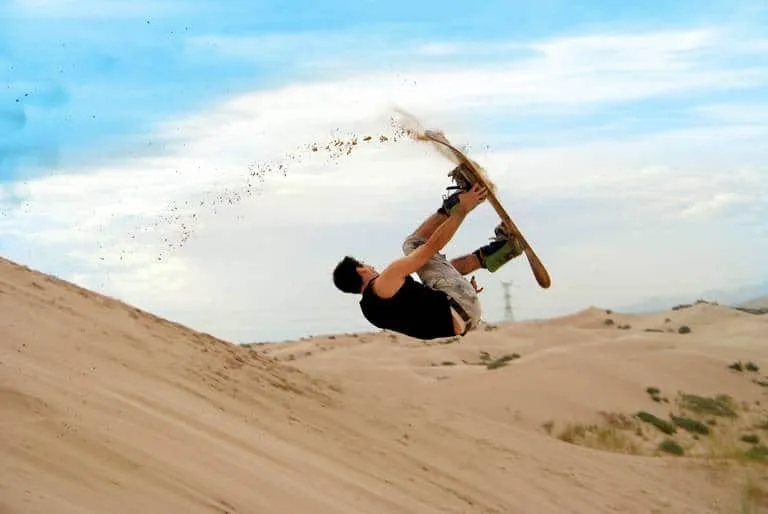 Sandboarder preparing to ride down a Samalayuca dune slope