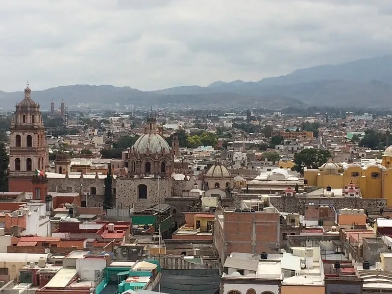 Historic rooftops in San Luis Potosi under bright late-spring sky