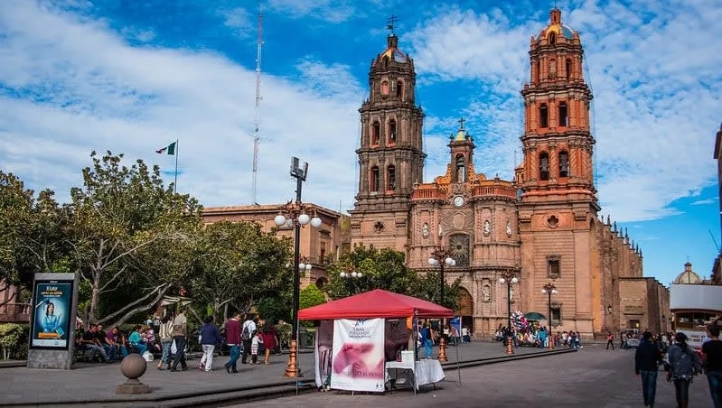 Pink stone cathedral facade facing Plaza de Armas in downtown San Luis Potosi