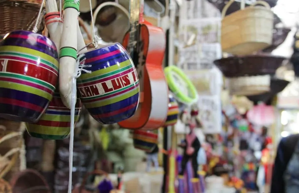 Busy San Luis Potosi market stalls with produce and regional food counters