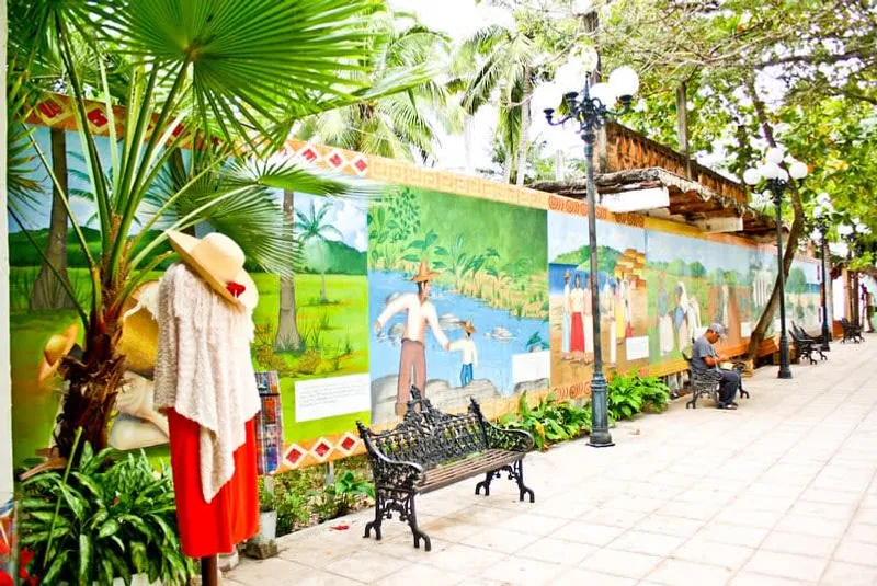 San Pancho village street with cafes, low buildings, and green hills rising behind town