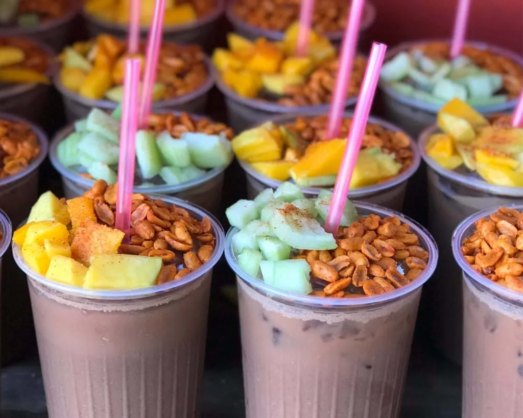 Pozol arrecho — the Chiapas and Tabasco cacao and corn drink served in a coconut bowl with fruit