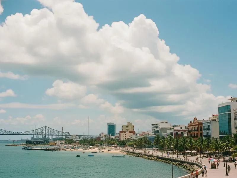 Humid Gulf Coast sky over Tampico with bright sun and building afternoon clouds