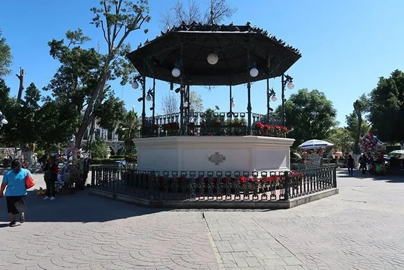 Parque Juarez central plaza in Tehuacan Puebla with sculpted topiary gardens and central kiosk on a sunny day