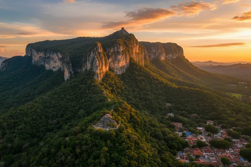 Green cliffs rising behind Tepoztlan rooftops during the October transition from rainy season