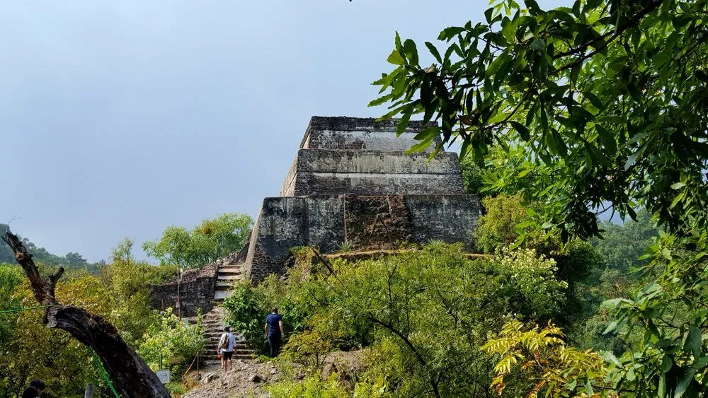 The Dominican Ex-Convent of the Nativity in Tepoztlán with its 16th-century facade, carved stone entrance, and museum rooms visible through the cloister
