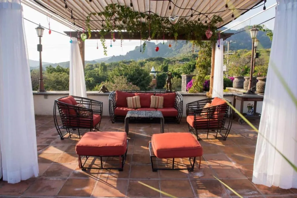 Boutique hotel in Tepoztlán with traditional Mexican architecture, garden courtyard, and views of the Tepozteco volcanic cliffs