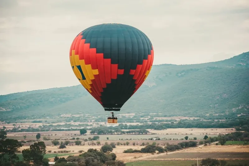 Hot air balloon near Tequisquiapan in July with rainy-season weather planning and Querétaro wine country views