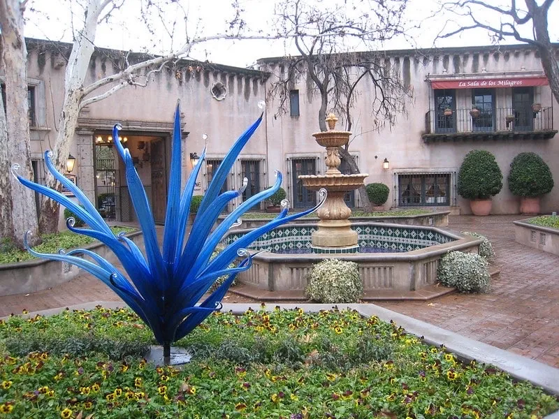 Colorful storefronts and artisan displays along a pedestrian street in Tlaquepaque