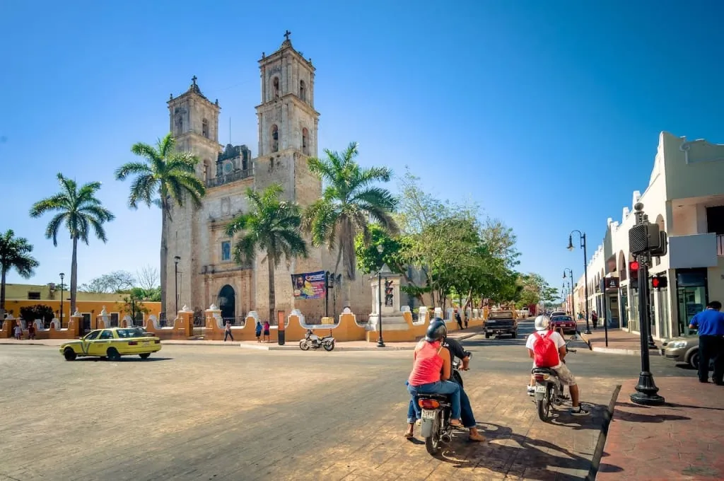 Horse carriage and pastel buildings in Valladolid historic center