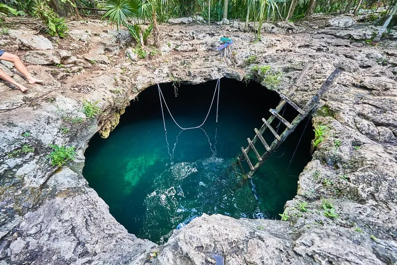 Cenote near Tulum with crystal-clear blue water — perfect for swimming and snorkeling
