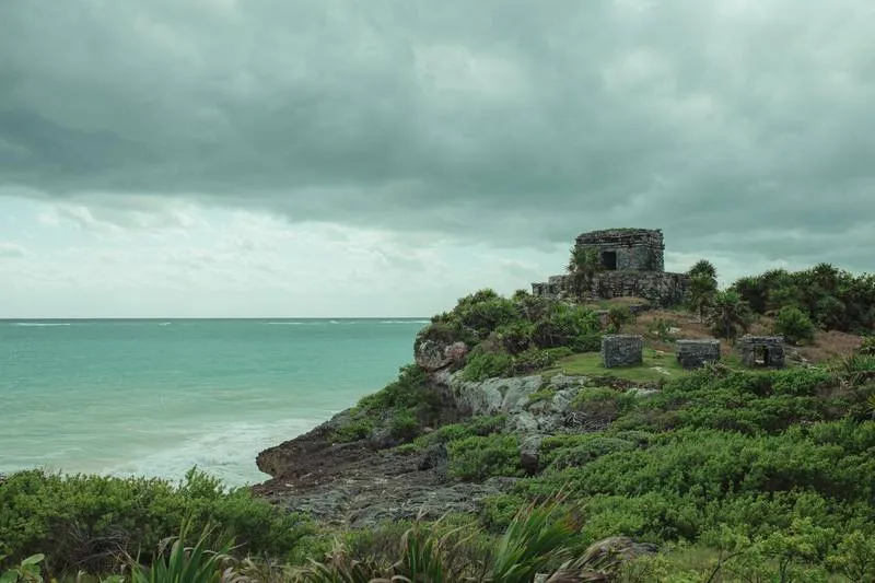 Tulum El Castillo temple perched on a limestone cliff above the turquoise Caribbean sea — the most dramatically situated Maya ruins in Mexico