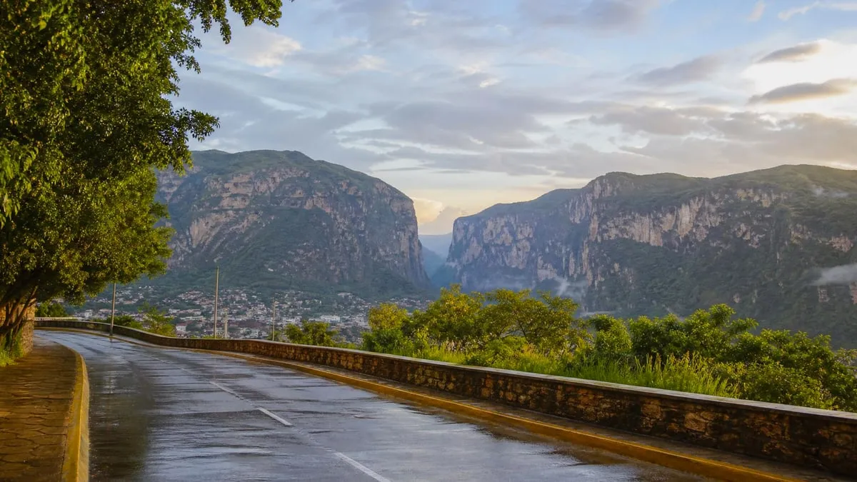 Green Chiapas hills and wet streets near Tuxtla Gutierrez after a July rainy-season shower
