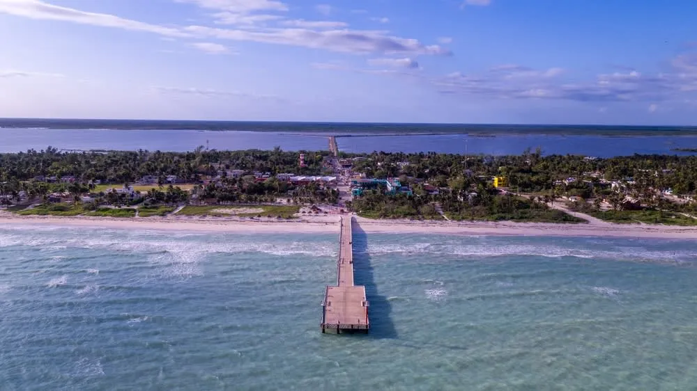 Quiet sandy beach and palm trees in El Cuyo, Yucatán