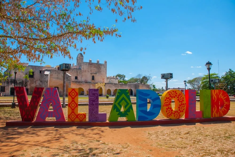 Valladolid main plaza with colonial arcades and tropical trees