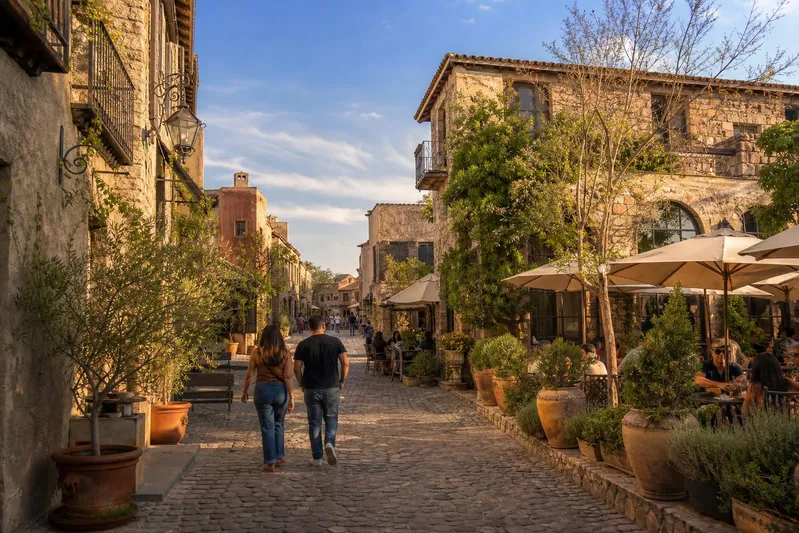 Stone street and Tuscan-style facades in Val'Quirico during dry March weather