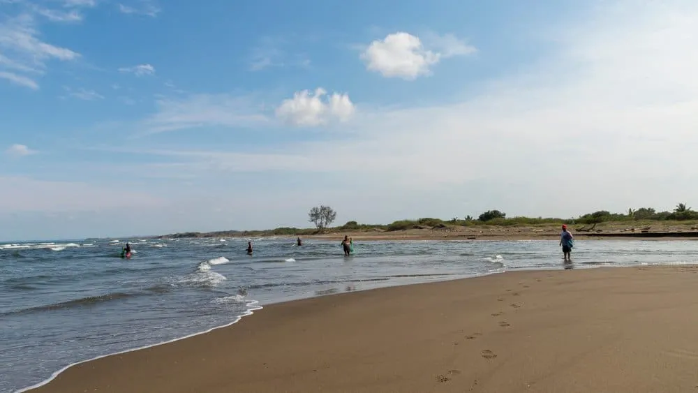 Wide sand at Playa Chachalacas with Gulf waves and dunes nearby
