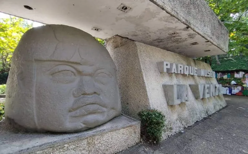 Stone Olmec head sculpture beside the entrance wall at La Venta Museum Park
