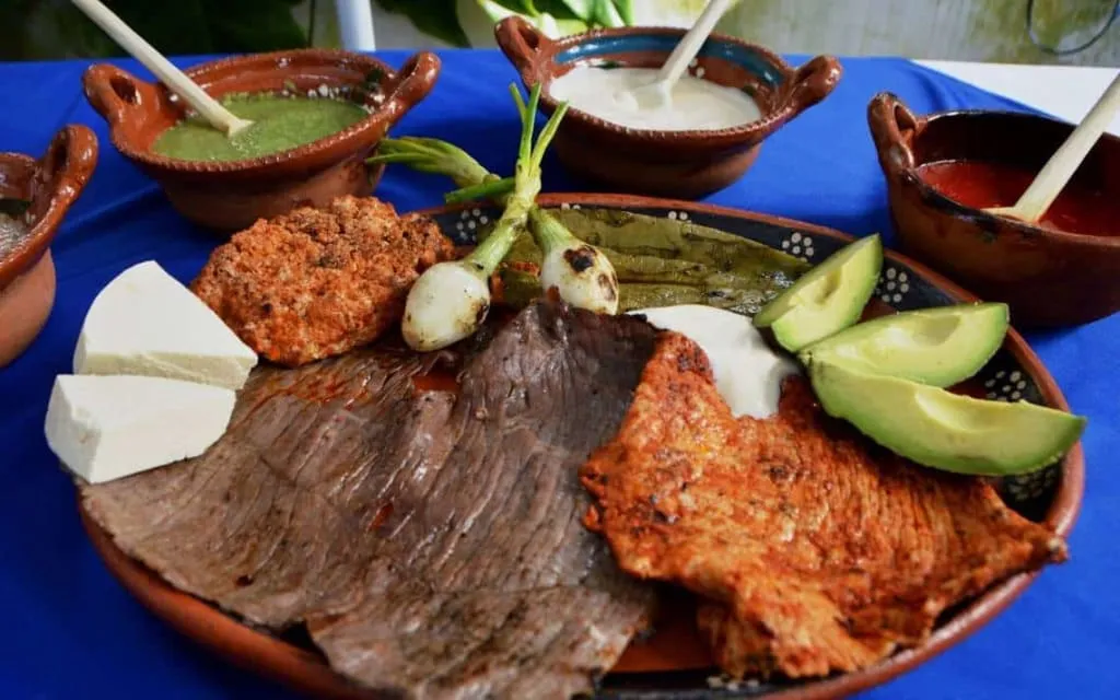 Classic cecina de Yecapixtla from Morelos — thin sheets of salted air-dried beef displayed at a market stall