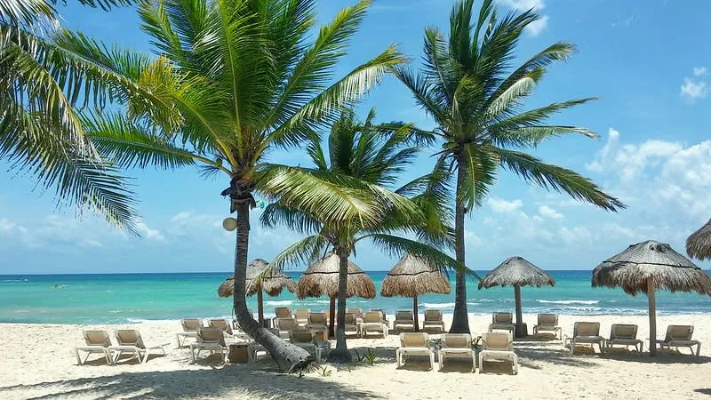Xcalacocos beach near Playa del Carmen with shallow water and coconut palms