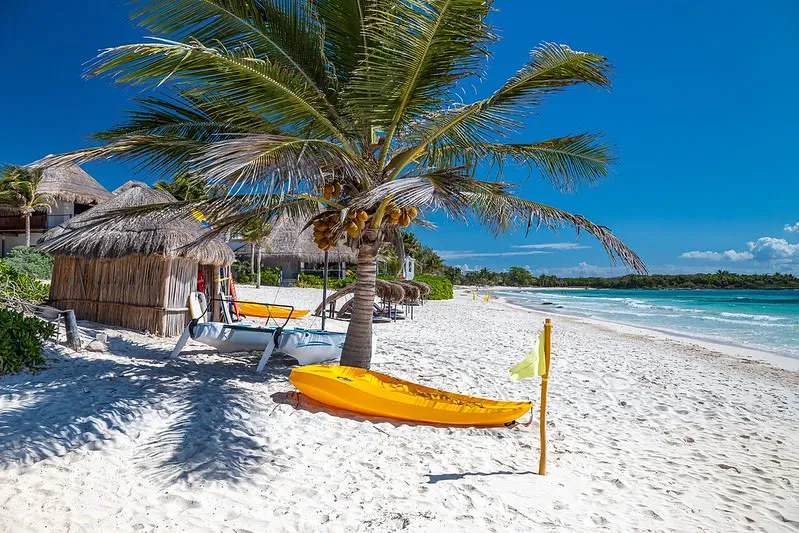 Quiet Xpu-Ha beach with shallow clear water and soft white sand