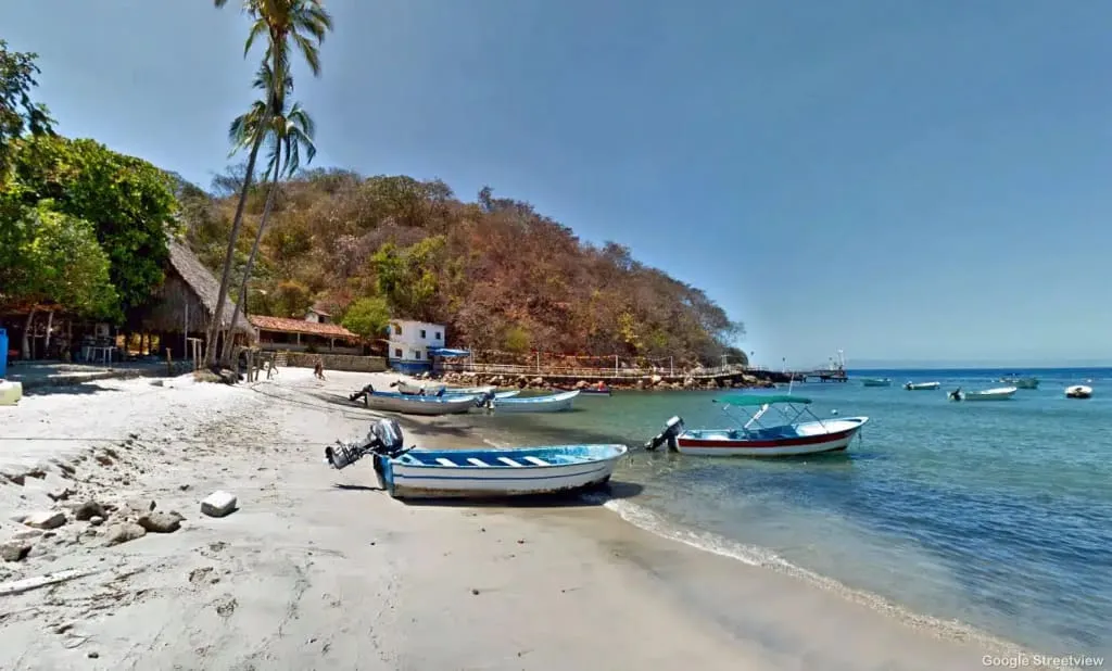 Calm water and restaurant palapas along Quimixto beach in Banderas Bay