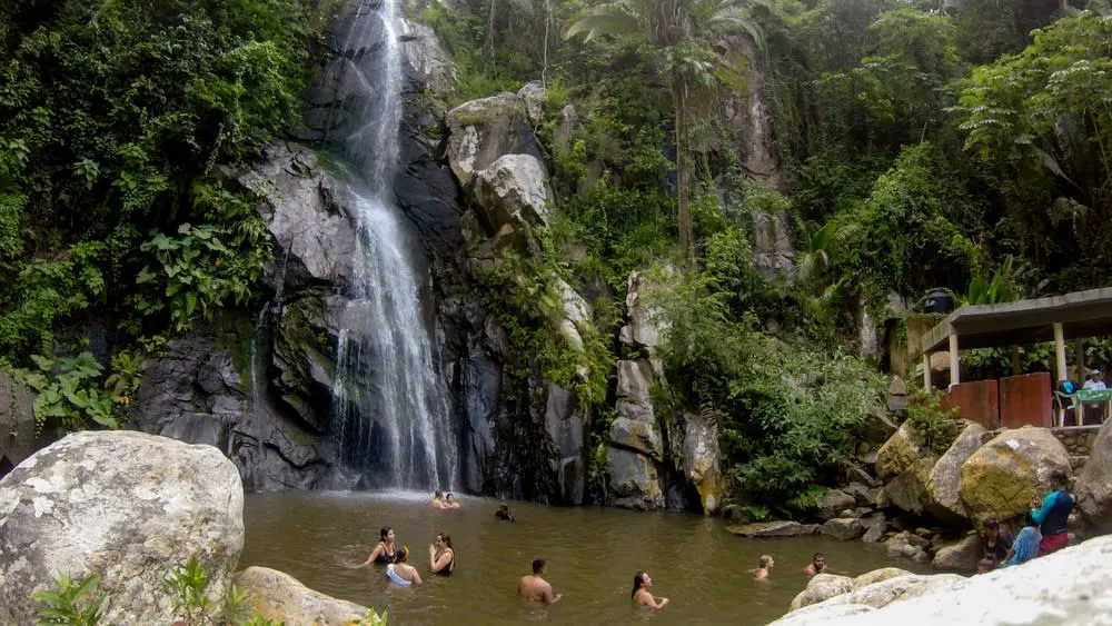 Yelapa waterfall spilling into a shaded jungle pool near the village
