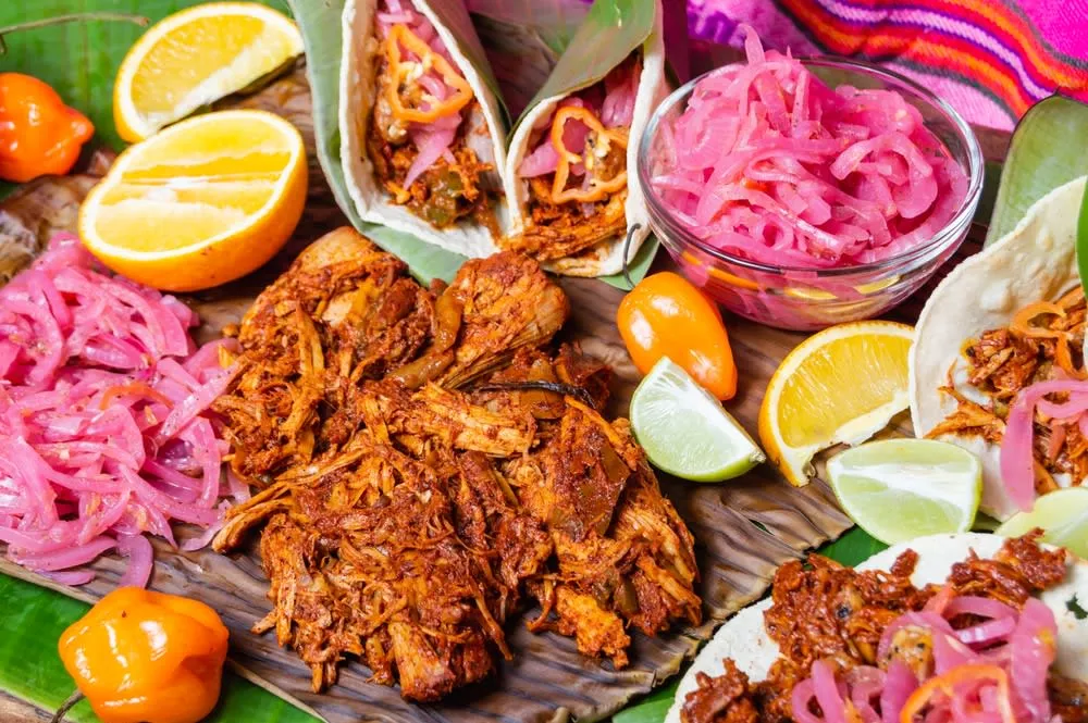 Cochinita pibil tacos served with pickled habanero red onions and handmade corn tortillas in Yucatan