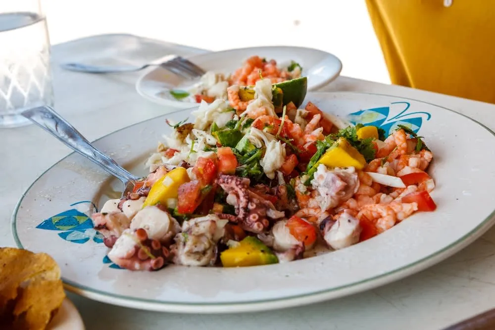 Yucatan-style ceviche with fresh fish, sour orange juice, habanero, and cilantro served with tostadas on the coast