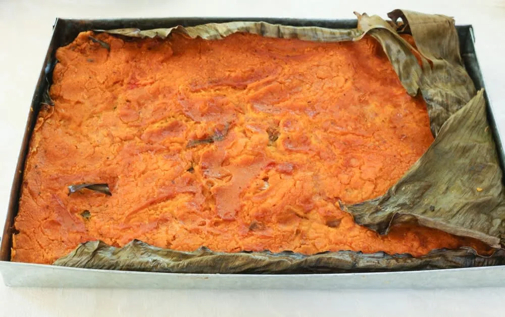 Mukbil pollo — large pibil-cooked tamale with chicken and masa wrapped in banana leaves for Yucatan Day of the Dead