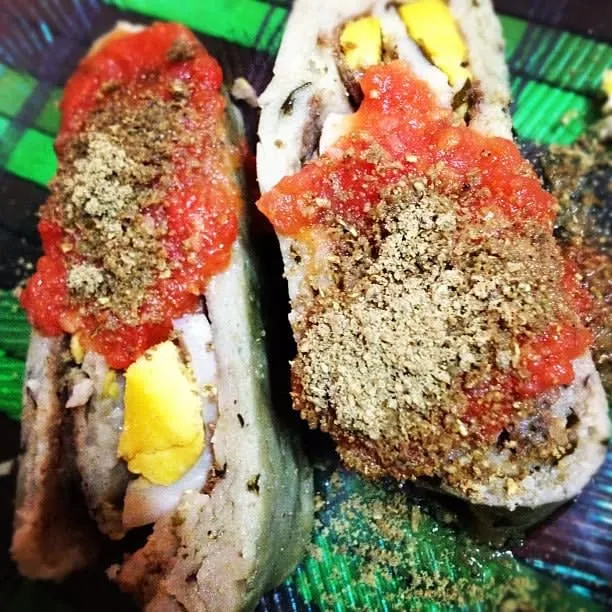 Brazo de reina — Yucatan tamale roll with chaya leaves, hard boiled egg, and pumpkin seeds wrapped in banana leaf