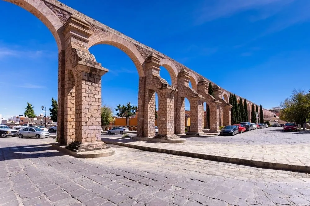 Historic Zacatecas aqueduct arches beside city streets
