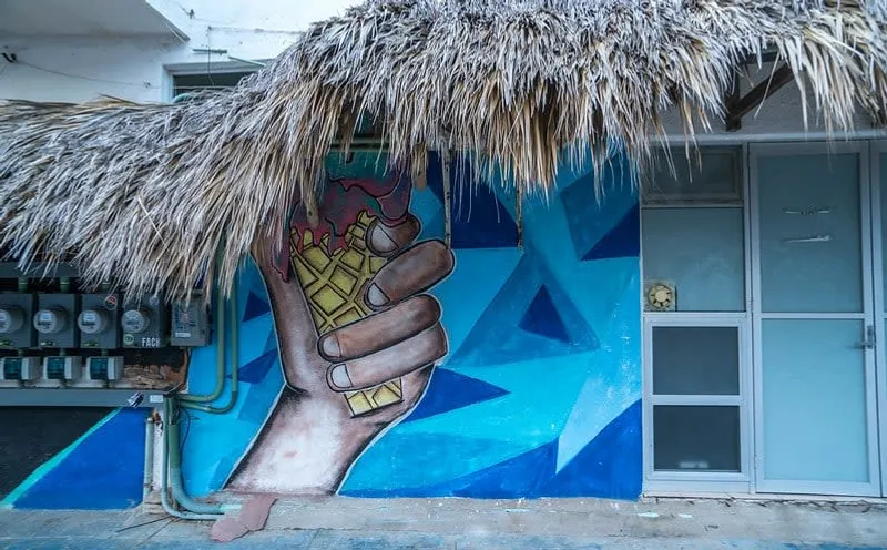 Colorful street art and sandy lanes in Zipolite during August rainy season