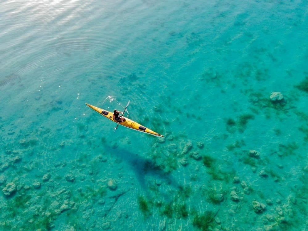 Freshwater swimmers near bright blue shallows on Bacalar's lagoon