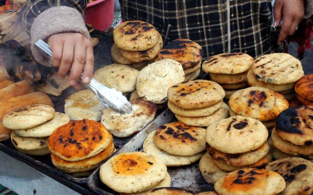 Bocoles and gorditas side by side — the bocol is thicker and rounder than the gordita