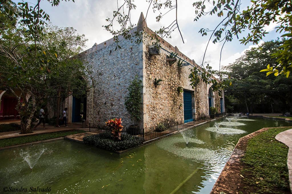 Stone hacienda building and reflecting pool at Selva Maya