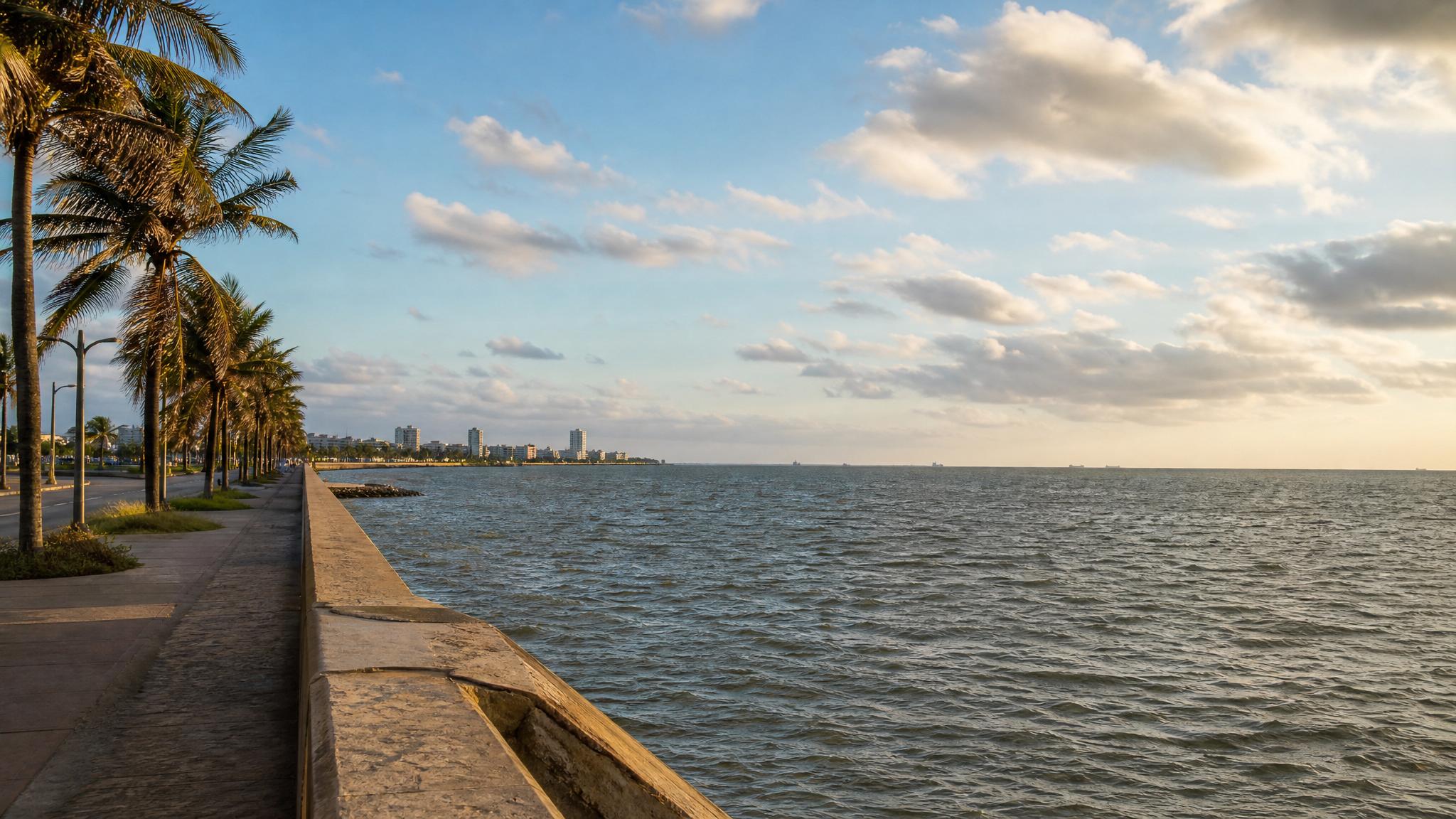 Coatzacoalcos malecon in February with Gulf water, palms, dry-season light, and a clear sky