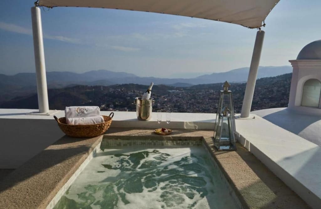 Terrace view of Taxco Guerrero colonial architecture with white buildings and terracotta rooftops on hillside
