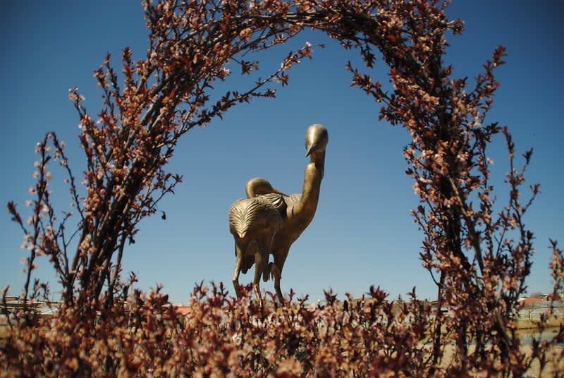 Lake Las Garzas in Guachochi with two bronze heron sculptures over 3 meters tall at the water's edge