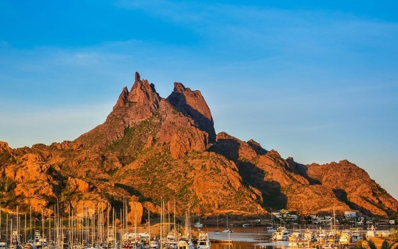 Rocky coastline near Guaymas and San Carlos under strong July sun and summer clouds