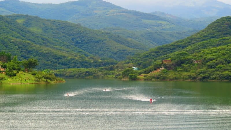 Jalpan de Serra dam in the Sierra Gorda with mountains, vegetation, and kayaking on calm water